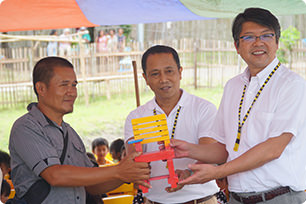 Both representatives presenting a chair